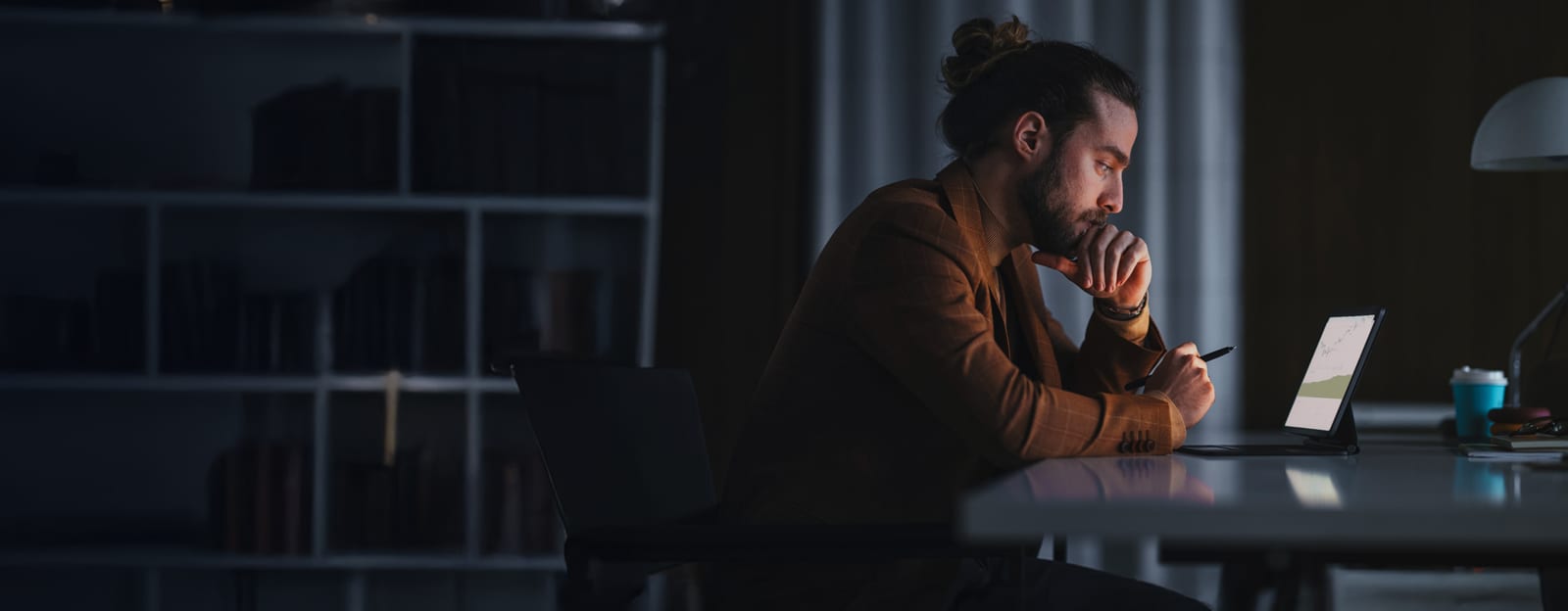 a man sitting in front of a tablet screen