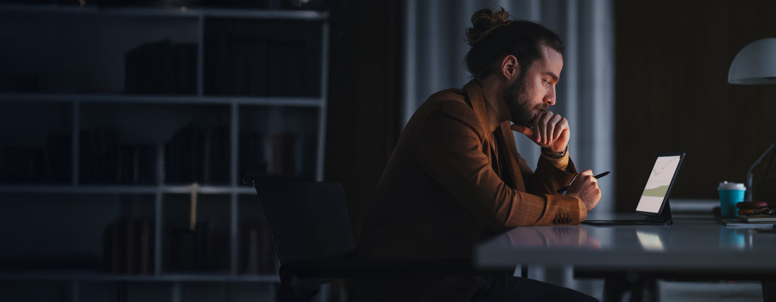 a man sitting in front of a tablet screen